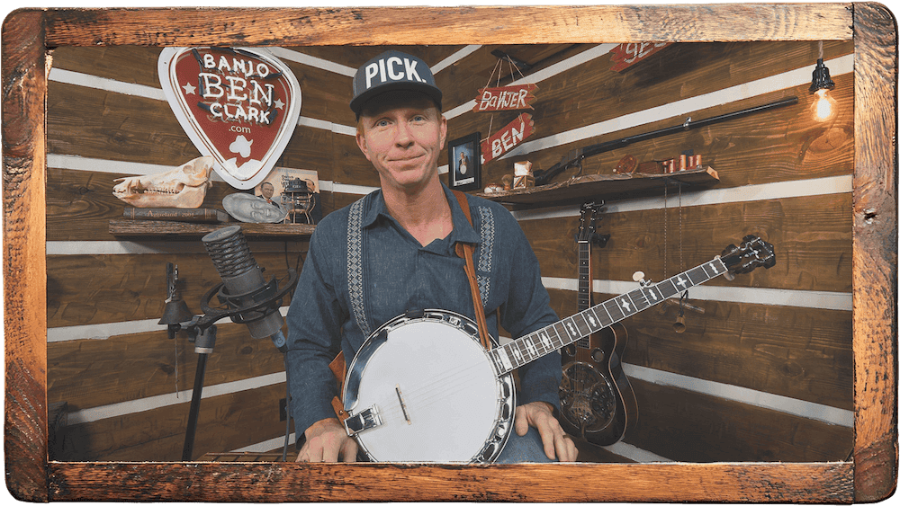 Banjo Ben Clark playing, framed in live-edge wood